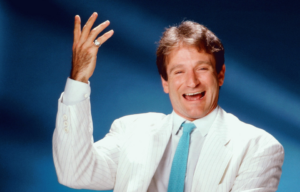 Robin Williams with his hand up.