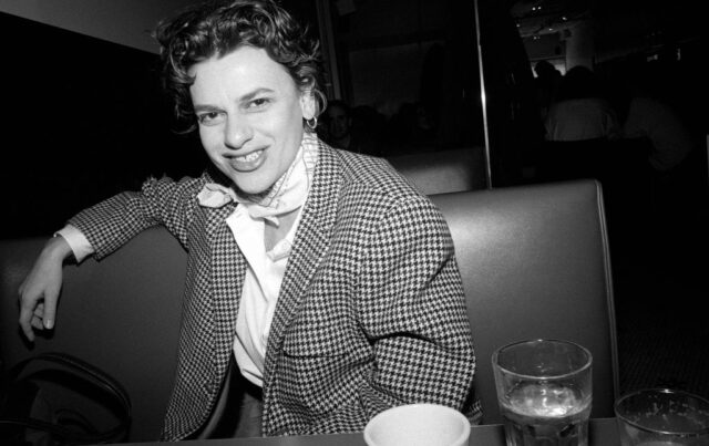 Sandra Bernhard sitting in a restaurant booth