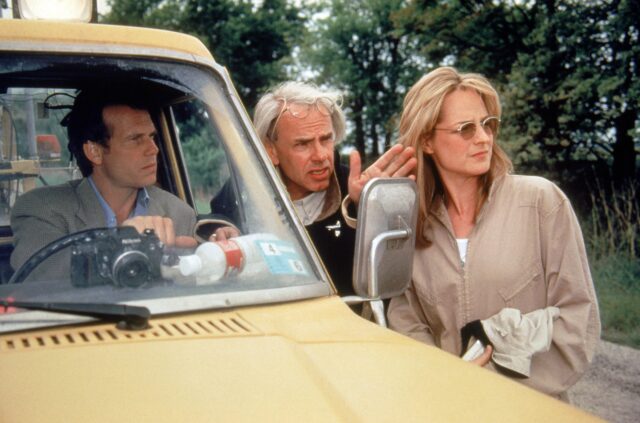 Bill Paxton, Helen Hunt and Jan de Bont standing on the set of 'Twister'