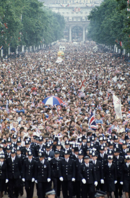 Police officers standing in front of a large crowd