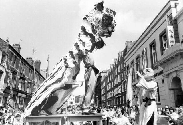 Lion dancing troupe performing in the middle of a street in Liverpool, United Kingdom