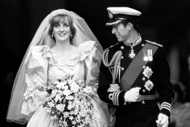 Princess Diana and Prince Charles walking together in wedding attire