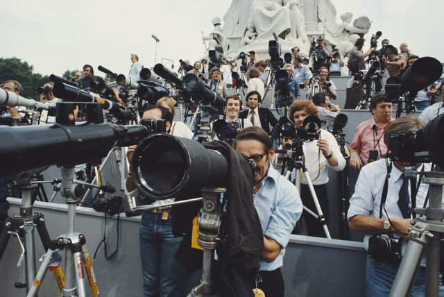 Members of the media standing behind cameras