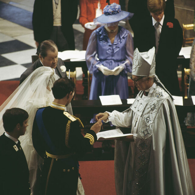 Lady Diana Spencer and Prince Charles standing before Robert Runcie, Archbishop of Canterbury