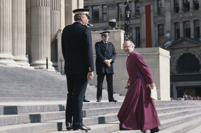 Robert Runcie, Archbishop of Canterbury, walking up stairs