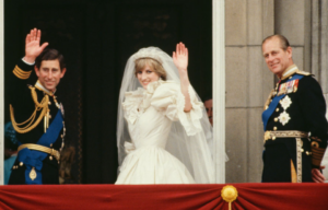 Prince Charles, Princess Diana and Prince Philip standing on the balcony of Buckingham Palace