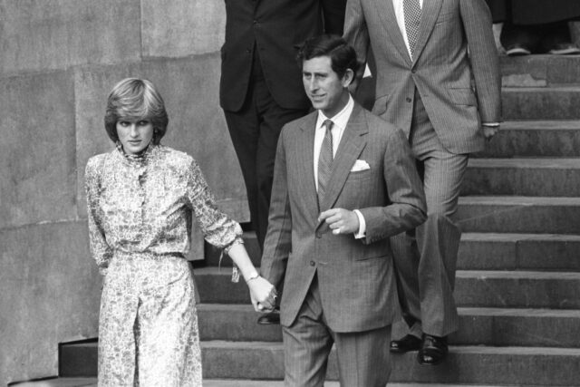 Lady Diana Spencer and Prince Charles walking together down a flight of stairs