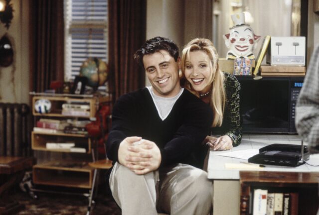 Matt LeBlanc and Lisa Kudrow standing on the set of 'Friends'