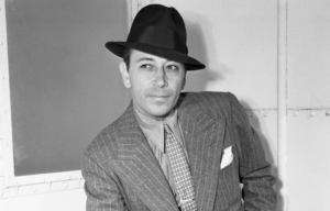 Headshot of George Raft wearing a hat.