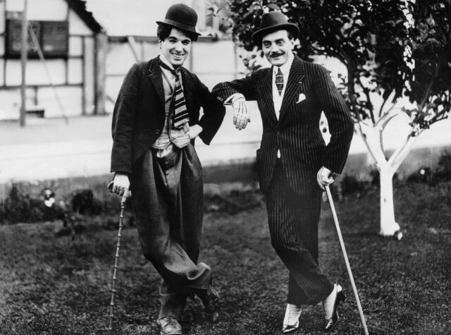 Max Linder and Charlie Chaplin standing together with canes