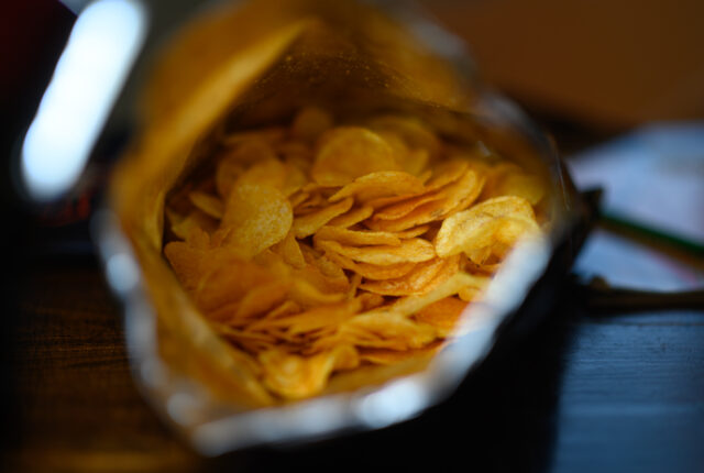 Looking into a bag of potato chips.