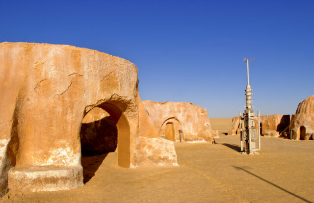 A 'Star Wars' prop standing outside a desert hut.