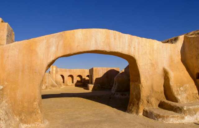 A terracotta arch in the desert.