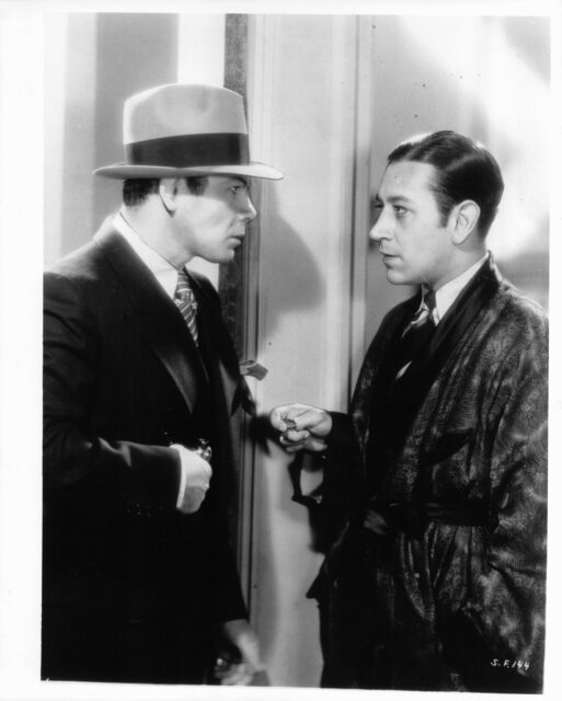 Paul Muni speaking with George Raft in a scene from 'Scarface.'