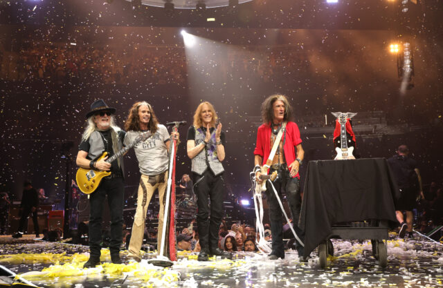 Members of Aerosmith standing on stage