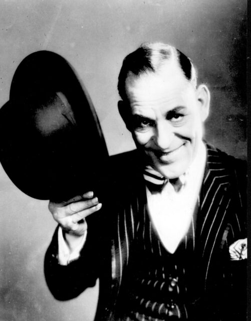 Lon Chaney tipping his hat in 'hello.'