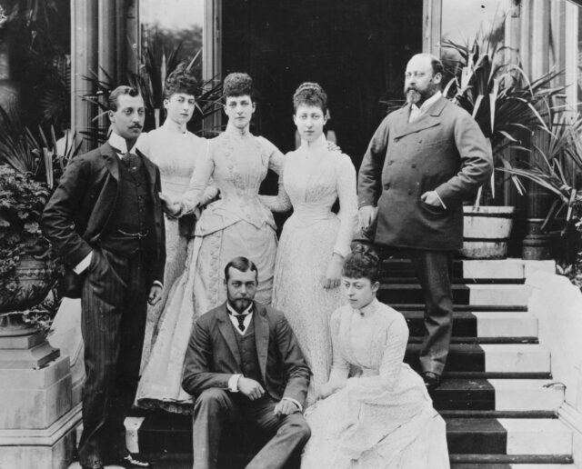 A portrait of the Royal family on a staircase.