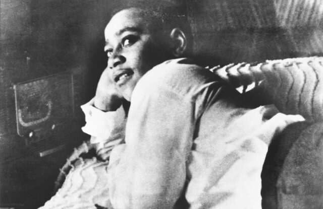 Emmett Till laying on his bed.