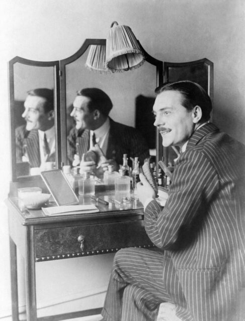 Max Linder sitting at a vanity table