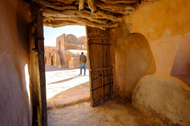 View looking out of a hut in the Tunisian desert, the door made of wood.