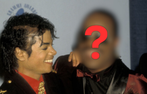 Michael Jackson standing with Stevie Wonder on a red carpet + Red question mark