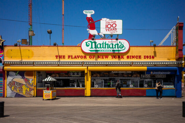 The storefront of a Nathan's Original restaurant.