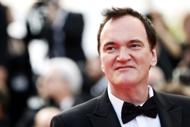 Quentin Tarantino standing on a red carpet