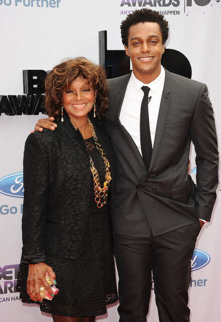 Rebbie Jackson and Austin Brown standing on a red carpet