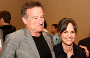 Robin Williams and Sally Field standing together in a crowd