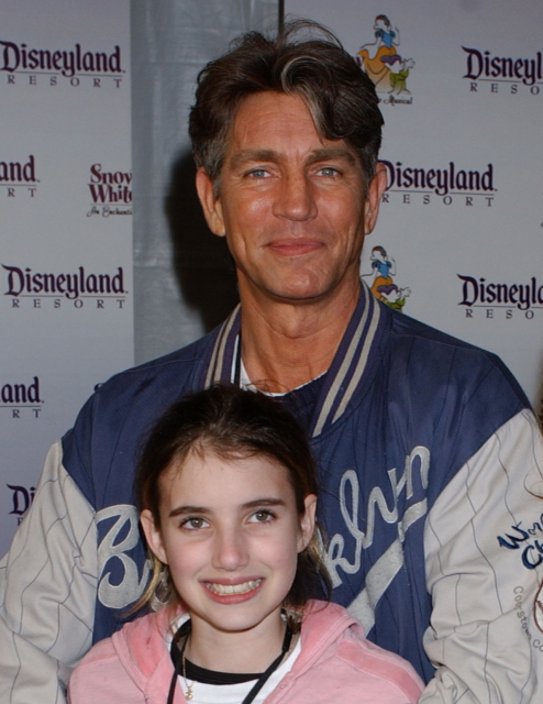 Eric and Emma Roberts standing on a red carpet