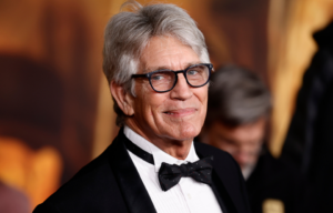 Eric Roberts standing on a red carpet