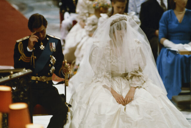 Princes Charles and Princess Diana sitting in chairs on their wedding day.