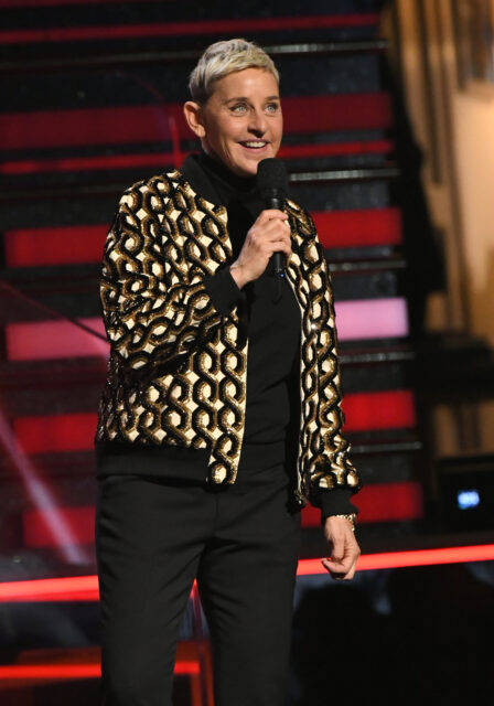 Ellen DeGeneres standing on stage, holding a microphone