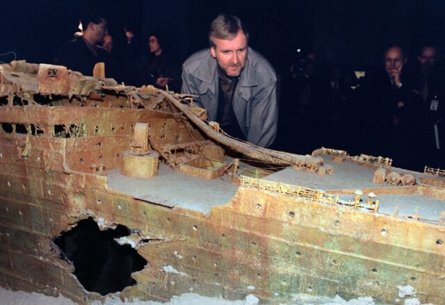 James Cameron looking at a model of the Titanic shipwreck.