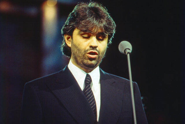 Andrea Bocelli singing into a microphone.