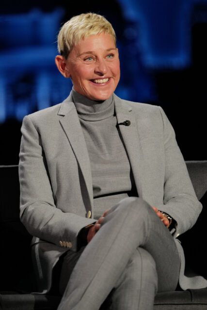 Ellen DeGeneres sitting on a couch