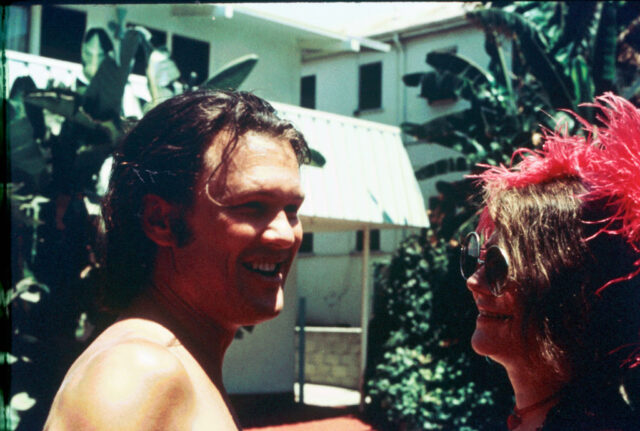 Kris Kristofferson standing with Janis Joplin outside of a building