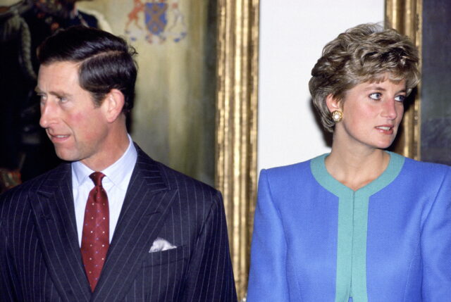 Prince Charles and Princess Diana looking in opposite directions.