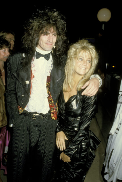 Tommy Lee and Heather Locklear standing together in a crowd