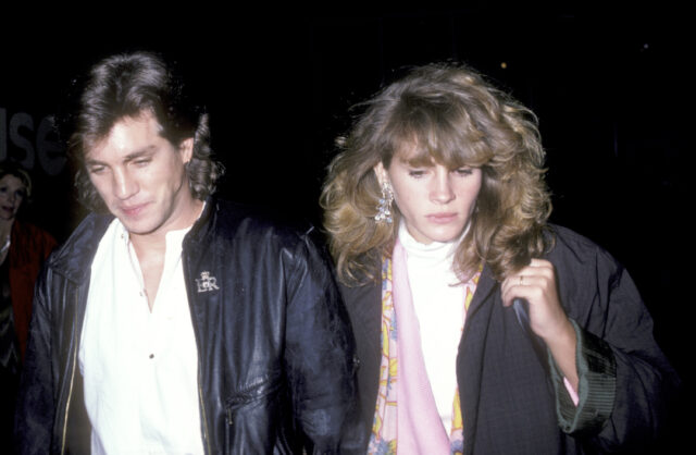 Eric Roberts and Julia Roberts walking together, both looking down.