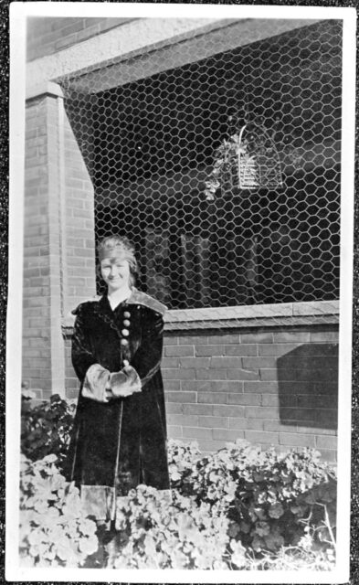 Gladys Pearl Baker standing outside of a building