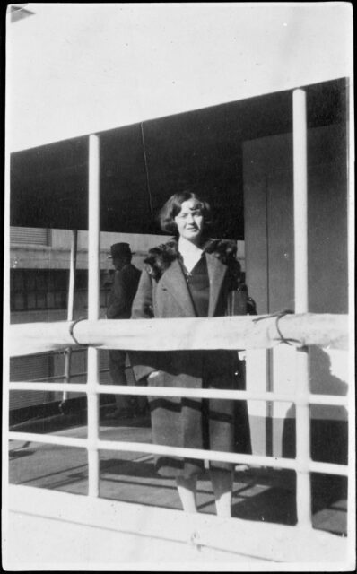 Gladys Pearl Baker standing at a fence