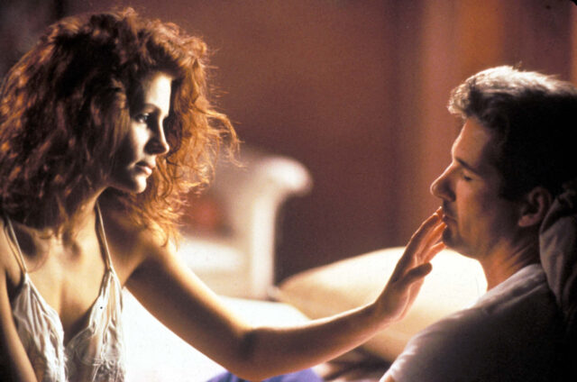 Julia Roberts touches Richard Gere's lips while he is asleep in a scene from 'Pretty Woman.'