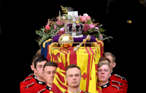 Several men holding the casket of Queen Elizabeth II.