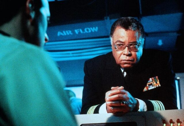 James Earl Jones in naval uniform leaning on a desk.