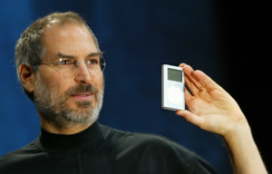 Steve Jobs holding up an iPod.