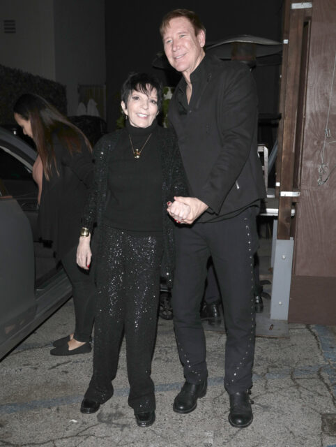 Liza Minnelli and an unidentified man standing together near a vehicle