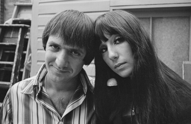 Sonny and Cher leaning their heads on one another.