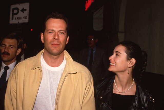 Demi Moore smiling at Bruce Willis.