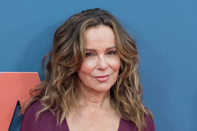 Jennifer Grey standing on a red carpet